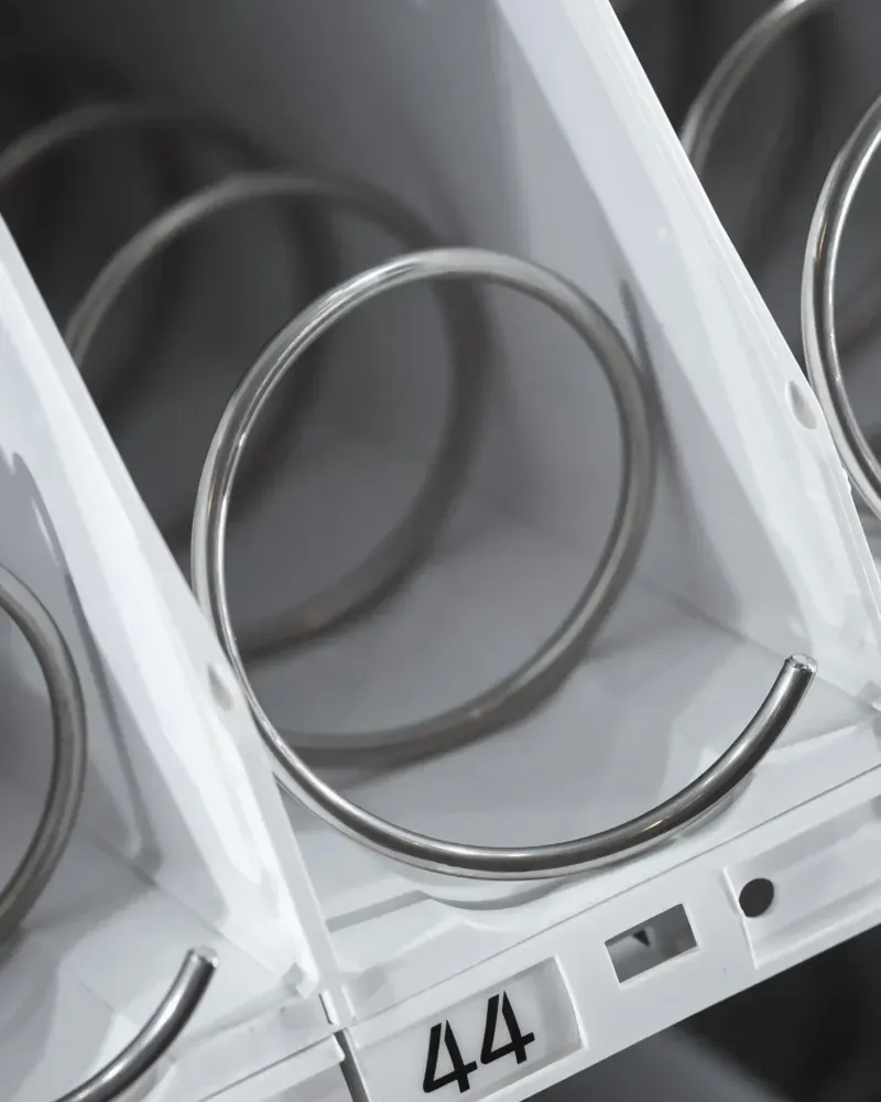 Close-up of the empty spiral coils and a numbered slot inside a snack vending machine