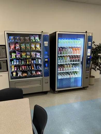 A snack and beverage vending machine pair, stocked and ready for use