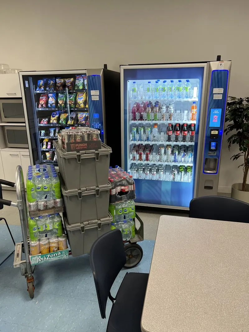 Glass-front vending machines installed in a bright staff breakroom