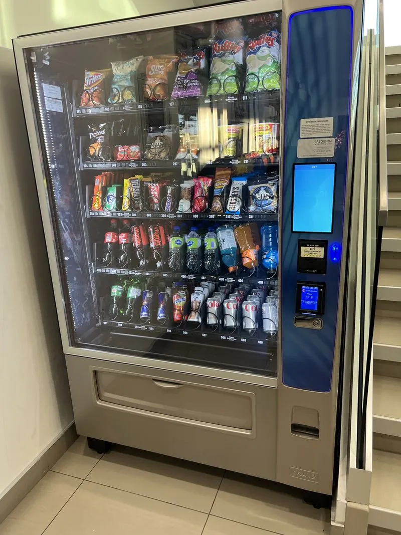 Rows of chips and snacks stocked inside an open vending machine