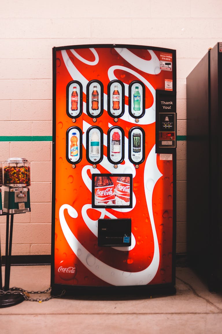 Vibrant indoor vending machine offering assorted sodas with eye-catching design.